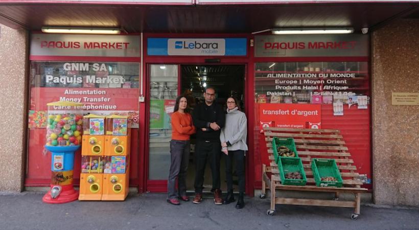 Gaddafi Muhammad devant son son échoppe, entouré par Maria Pérez, du Parti du travail